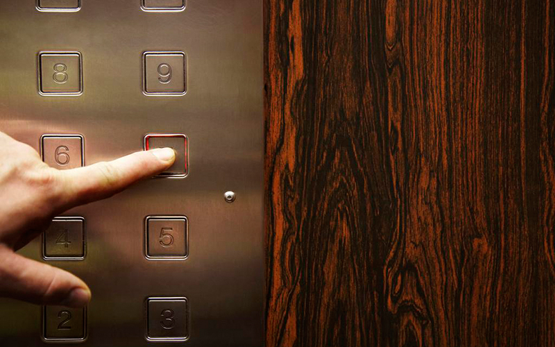 The function and usage of each button in the elevator car